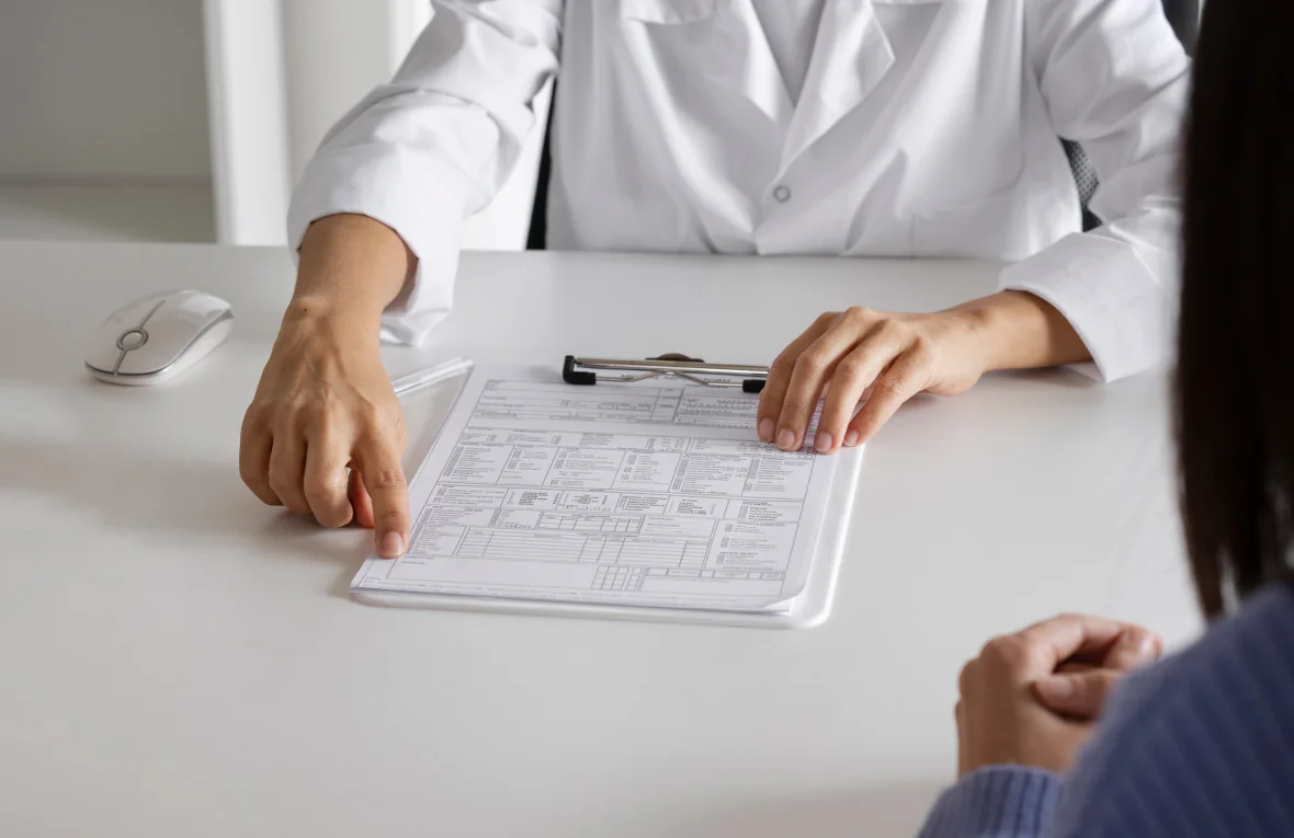 Doctor checking patient’s record sheet during Chronic Disease Management