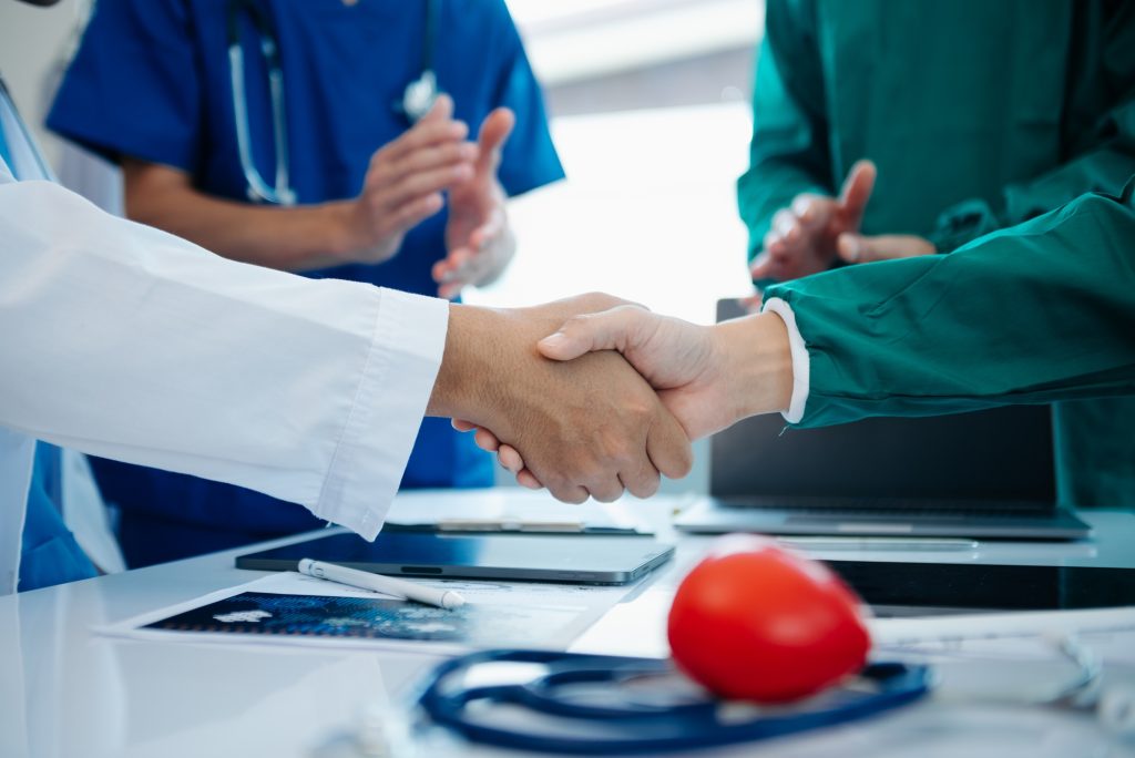 Doctor handshake and partnership in healthcare, medicine or trust for collaboration,